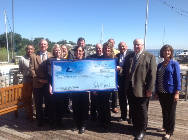 On deck in October are (l-r) Mel Stinson, GBSI, chapter vice president for plans and programs; Patrick Rooney, Coastal CXO Services, chapter treasurer; Robyn S. Philips, AppRiver, chapter vice president for awards and education/public affairs officer; Tom Hestle, Tek Source USA, AFCEA member; Rear Adm. Paul E. Tobin Jr., USN (Ret.); Karen Sindel, National Flight Academy; Hank Gonzalez, National Flight Academy/ Naval Aviation Museum Foundation trustee; Frank Smith, GBSI, chapter vice president for membership; Jessica Skower, GBSI, chapter secretary; Randy Ramos, GBSI, chapter president; Thomas Tom Gwaltney, regional vice president, Mid-South Region; and Terri Ramos, GBSI, chapter vice president for fundraising.